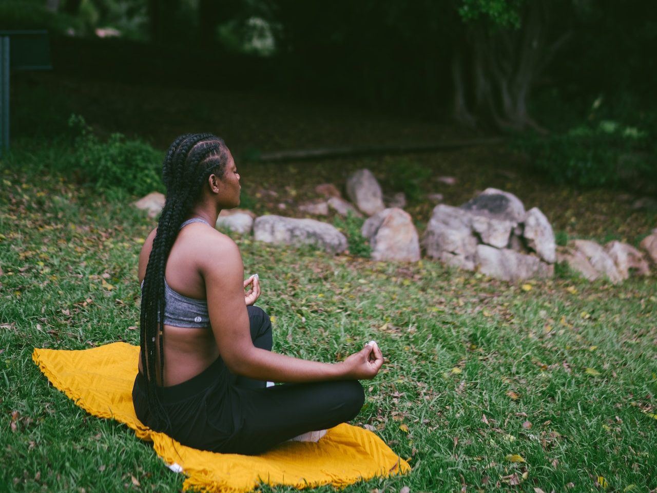 A woman meditating to illustrate stress reduction techniques.