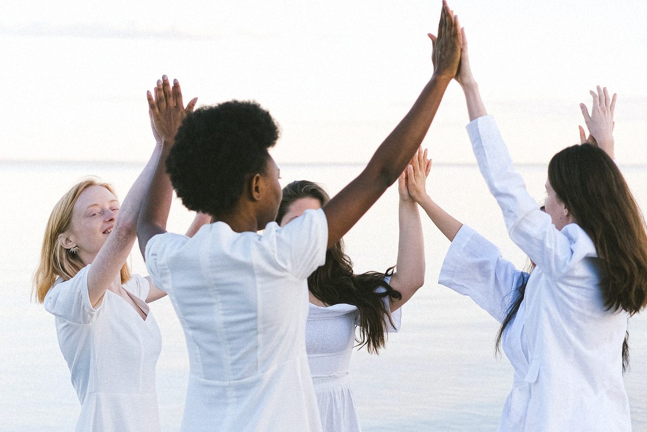 Community women joining hands together in support of each other